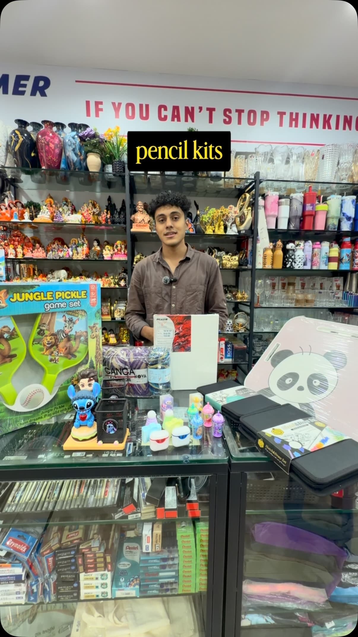 A Raj Krafts team member holding up pencil kits at the counter